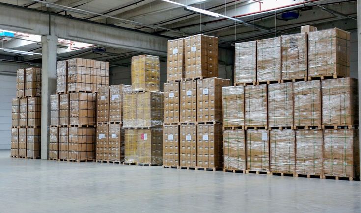 Freight on Pallets double and triple stacked inside a warehouse.